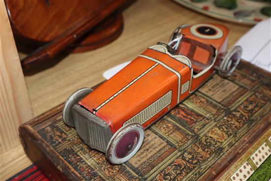 A Chad Valley tinplate racing car and a collection of other tinplate clockwork models,